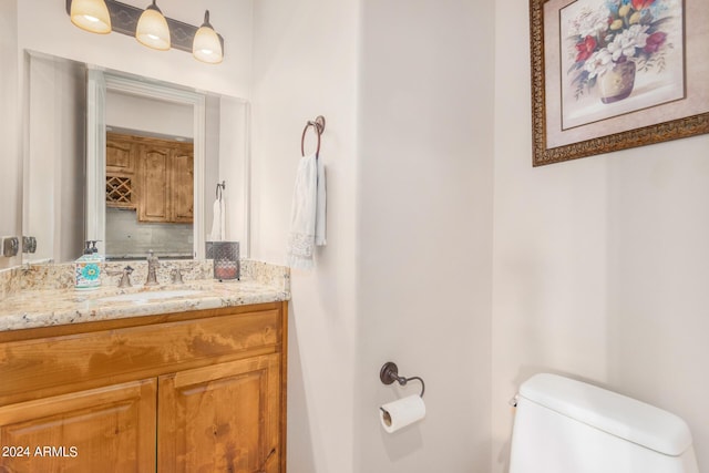 half bathroom featuring toilet and vanity