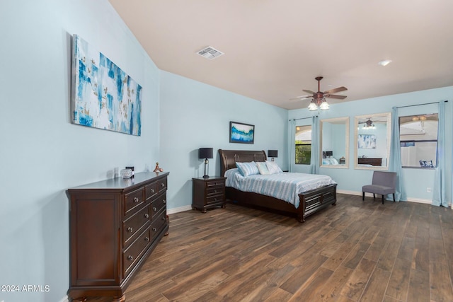 bedroom with baseboards, ceiling fan, dark wood-style flooring, and visible vents