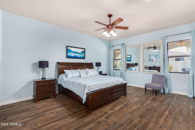 bedroom featuring a ceiling fan, baseboards, and dark wood-type flooring