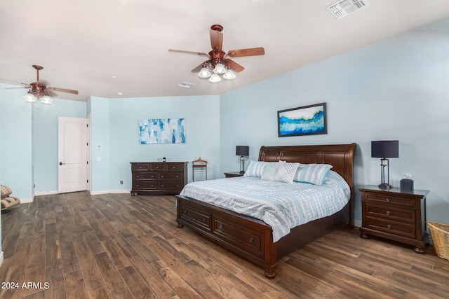 bedroom featuring ceiling fan, baseboards, visible vents, and wood finished floors