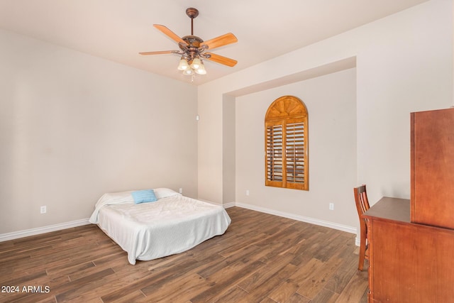 bedroom with baseboards, ceiling fan, and wood finished floors