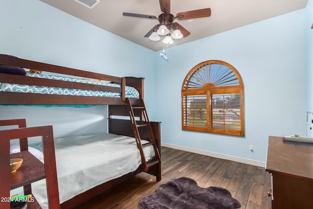 bedroom featuring baseboards, visible vents, and wood finished floors