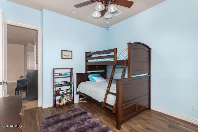 bedroom featuring baseboards, a ceiling fan, and wood finished floors