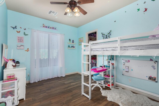 bedroom featuring a ceiling fan, baseboards, visible vents, and wood finished floors