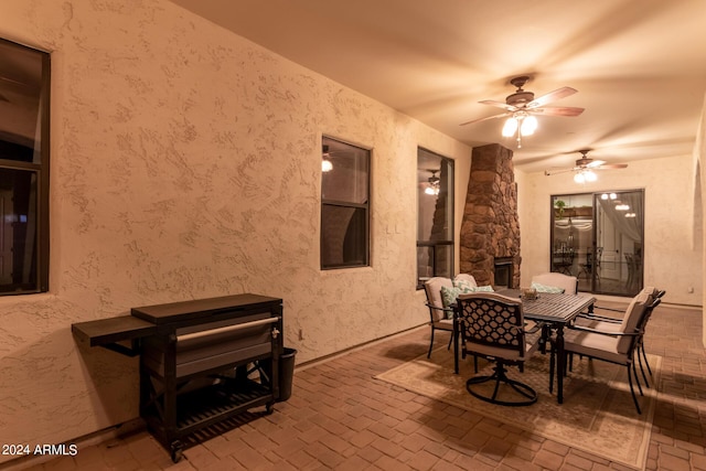 view of patio with outdoor dining area and a ceiling fan