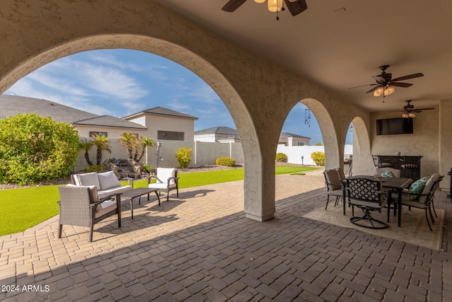 view of patio / terrace featuring ceiling fan, a fenced backyard, outdoor dining space, and an outdoor hangout area