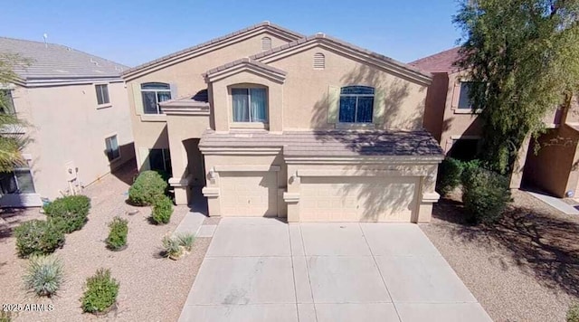 view of front of house featuring a garage, stucco siding, and concrete driveway