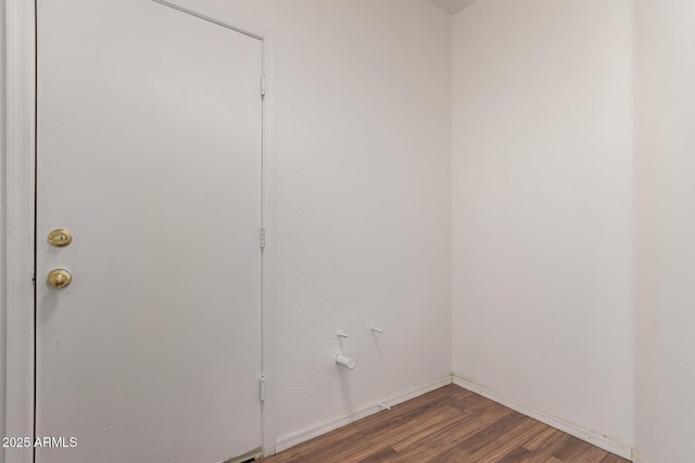 empty room featuring baseboards and wood finished floors