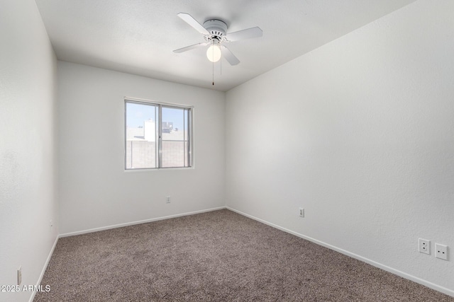 empty room with carpet, baseboards, and a ceiling fan