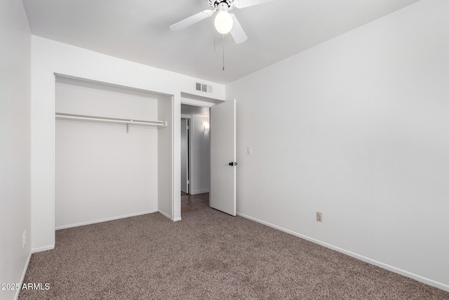 unfurnished bedroom featuring a closet, baseboards, carpet flooring, a ceiling fan, and visible vents
