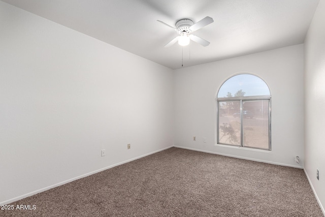 empty room with carpet floors, ceiling fan, and baseboards