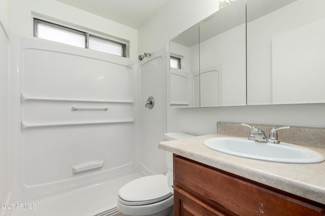 full bathroom featuring toilet, a shower, and vanity