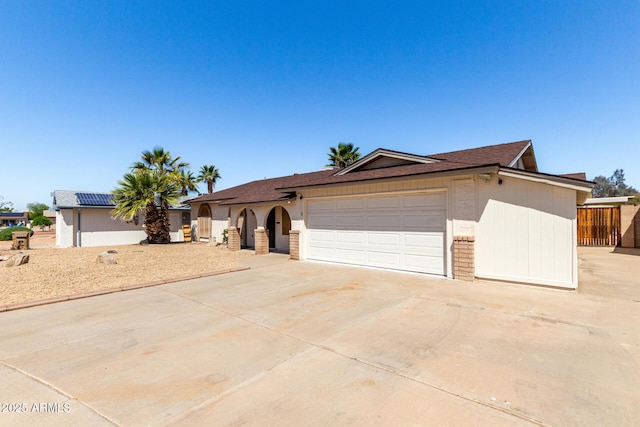 ranch-style home with a garage and driveway