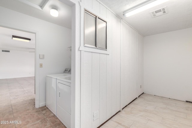 laundry room with visible vents, independent washer and dryer, and laundry area