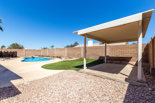 exterior space with a patio area, a fenced in pool, and a fenced backyard