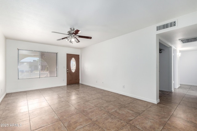 tiled entryway featuring ceiling fan, baseboards, and visible vents