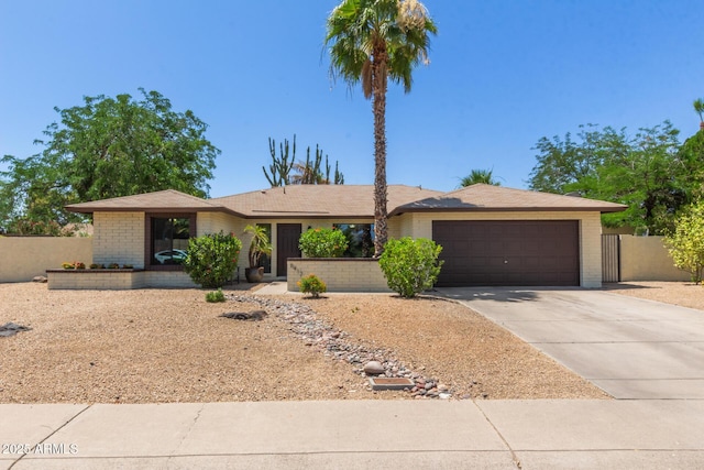 6417 E Kings Ave, Scottsdale, AZ 85254 - view of front of property featuring driveway, an attached garage, and brick siding