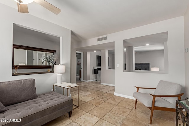 6417 E Kings Ave, Scottsdale, AZ 85254 - living area featuring stone tile floors and a ceiling fan