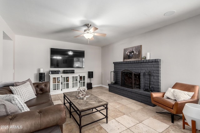 6417 E Kings Ave, Scottsdale, AZ 85254 - living room featuring a ceiling fan, a brick fireplace, and light stone finish flooring