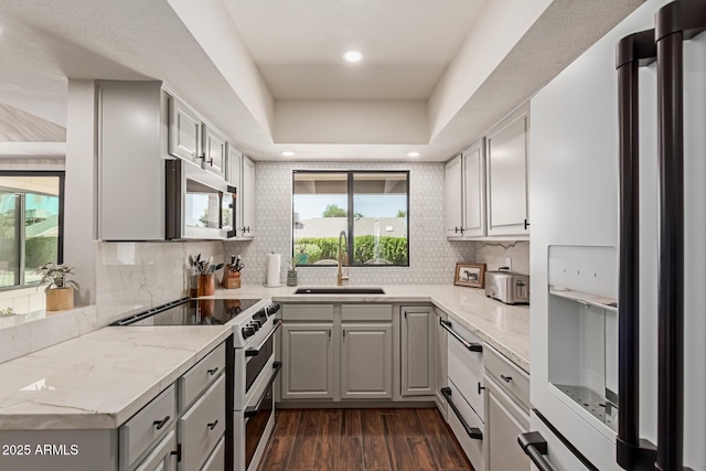 6417 E Kings Ave, Scottsdale, AZ 85254 - kitchen featuring white appliances, dark wood-type flooring, tasteful backsplash, gray cabinets, and a tray ceiling