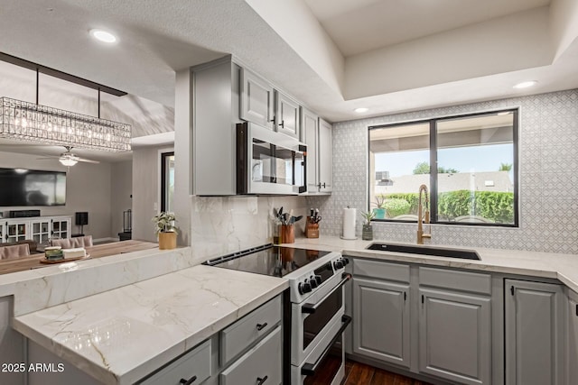 6417 E Kings Ave, Scottsdale, AZ 85254 - kitchen with gray cabinetry, stainless steel microwave, range with two ovens, ceiling fan, and recessed lighting