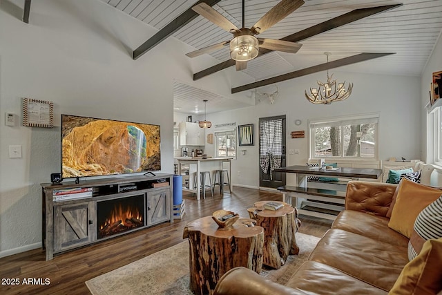 living room with a wealth of natural light, beam ceiling, baseboards, and dark wood-type flooring