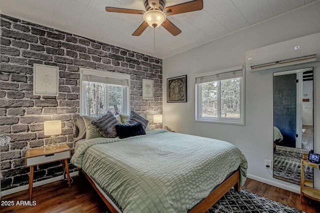 bedroom with ceiling fan, baseboards, wood finished floors, and a wall mounted air conditioner