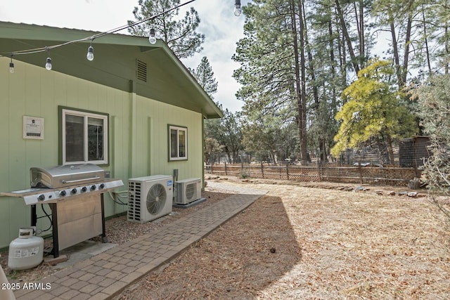 exterior space featuring ac unit and fence