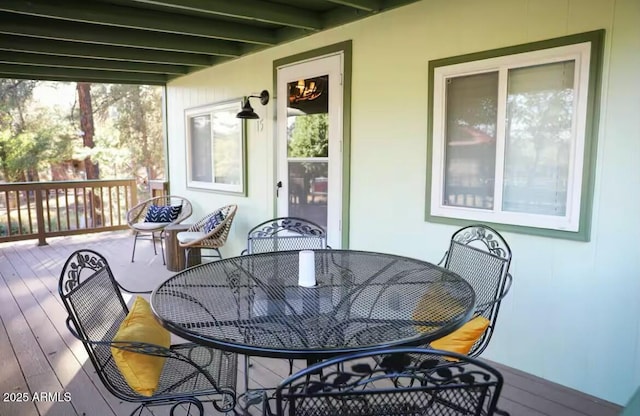 wooden terrace with outdoor dining space