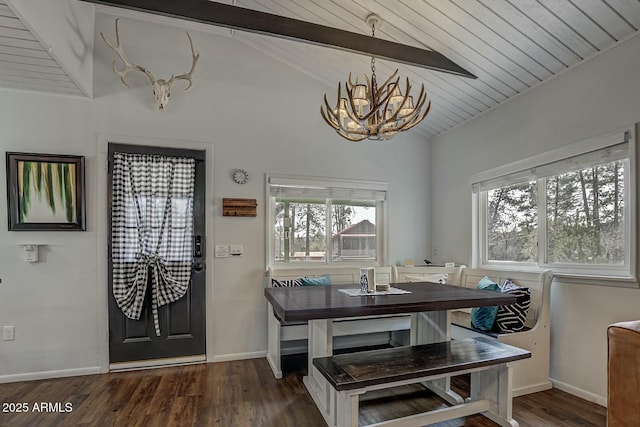 dining room featuring vaulted ceiling with beams, dark wood finished floors, and an inviting chandelier