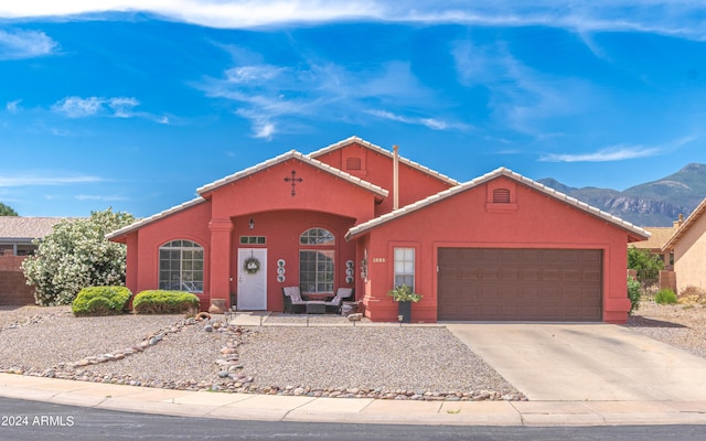 view of front of house featuring a mountain view and a garage