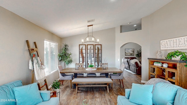 dining space featuring hardwood / wood-style flooring and lofted ceiling