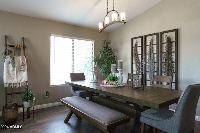 dining area featuring dark hardwood / wood-style flooring, lofted ceiling, and an inviting chandelier