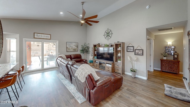 living room featuring high vaulted ceiling, light hardwood / wood-style flooring, and ceiling fan