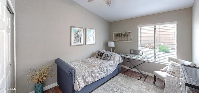 bedroom with ceiling fan, wood-type flooring, lofted ceiling, and a closet