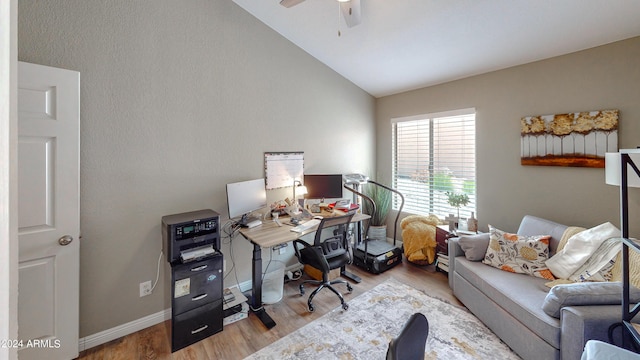 home office featuring light wood-type flooring, ceiling fan, and lofted ceiling