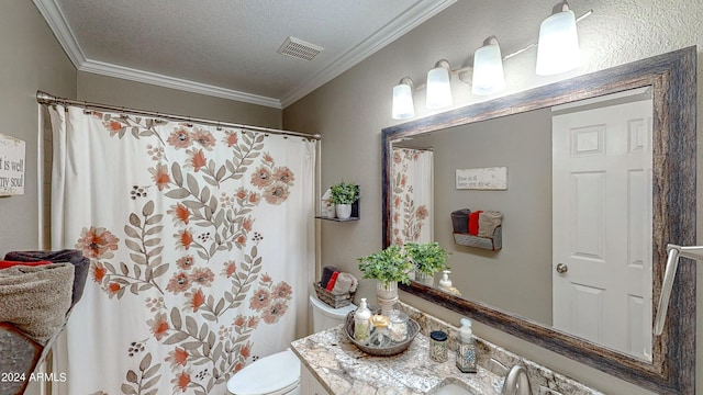 bathroom featuring a textured ceiling, vanity, toilet, and crown molding