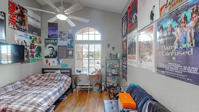 bedroom with ceiling fan, lofted ceiling, and hardwood / wood-style flooring