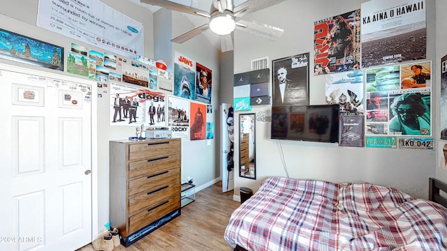 bedroom with ceiling fan and light hardwood / wood-style floors