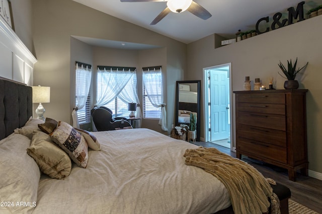 bedroom featuring dark hardwood / wood-style floors, ceiling fan, and lofted ceiling