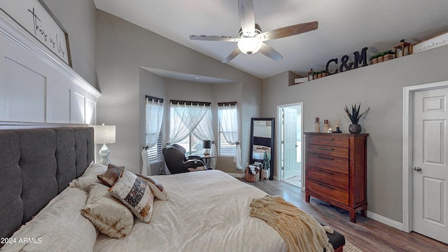 bedroom with ceiling fan, light wood-type flooring, and vaulted ceiling