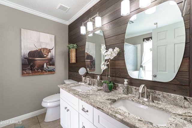 bathroom with tile patterned floors, crown molding, vanity, and toilet