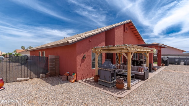 view of home's exterior with a pergola and a patio area