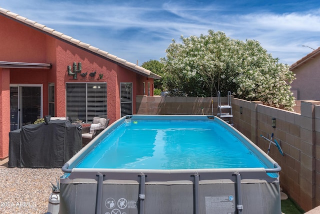 view of swimming pool featuring grilling area