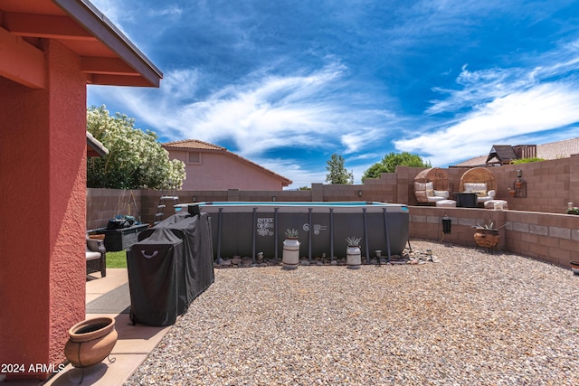 view of yard with a fenced in pool