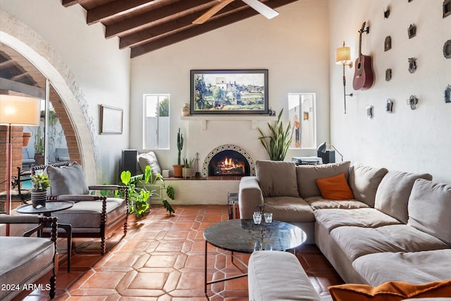 living room with beam ceiling and high vaulted ceiling