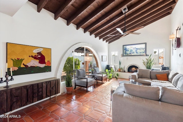 living room featuring wooden ceiling, high vaulted ceiling, tile patterned flooring, ceiling fan, and beam ceiling