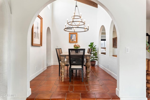 tiled dining area featuring a chandelier