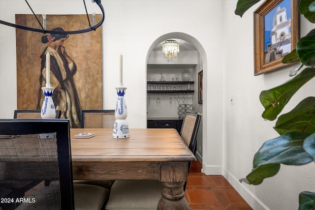 tiled dining space featuring a chandelier