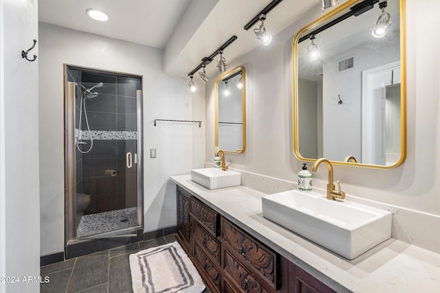 bathroom with vanity, toilet, and an enclosed shower